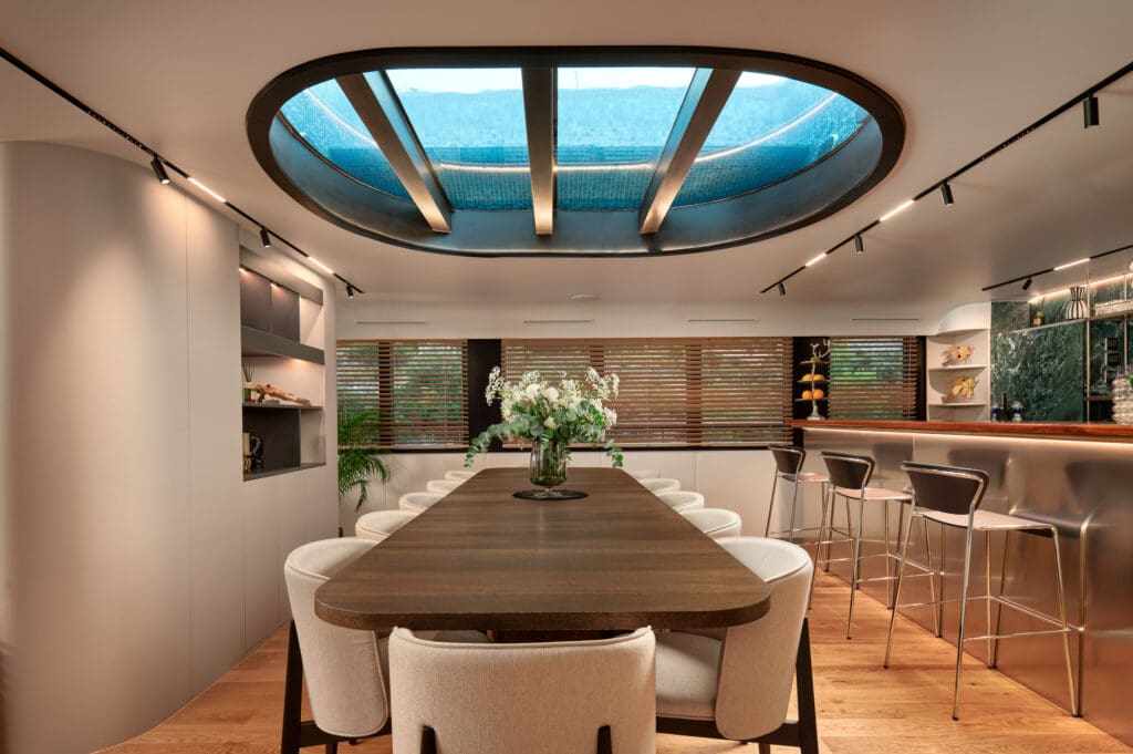 Luxury yacht dining room with glass bottom pool above.